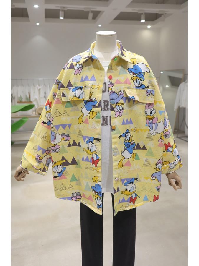 yellow oversized shirt with cartoon print of Disney's Donald Duck and Daisy Duck