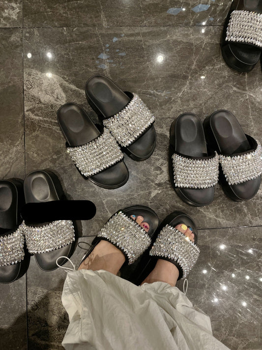 Black platform slide sandals with all-over shimmering crystal embellishments.