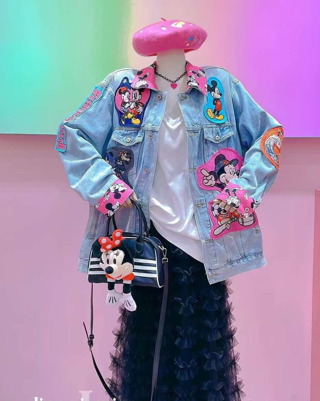 Patched light blue denim jacket with Disney characters.