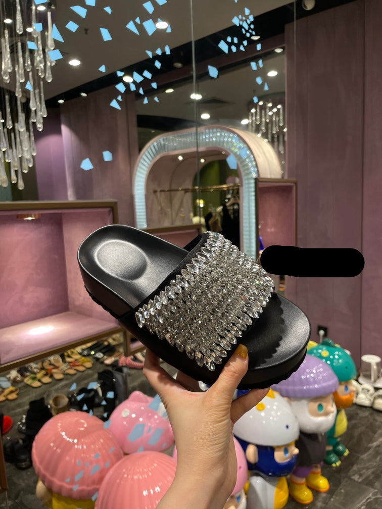 Black platform slide sandals with all-over shimmering crystal embellishments.