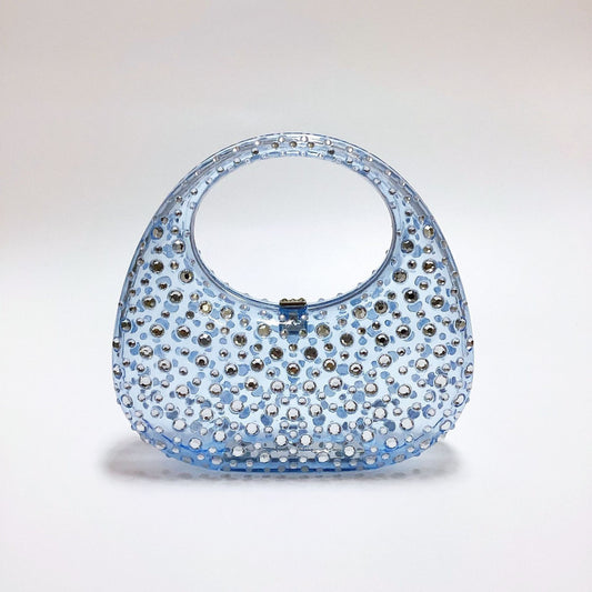 Clear blue acrylic crescent handbag with crystal embellishments and a top handle.