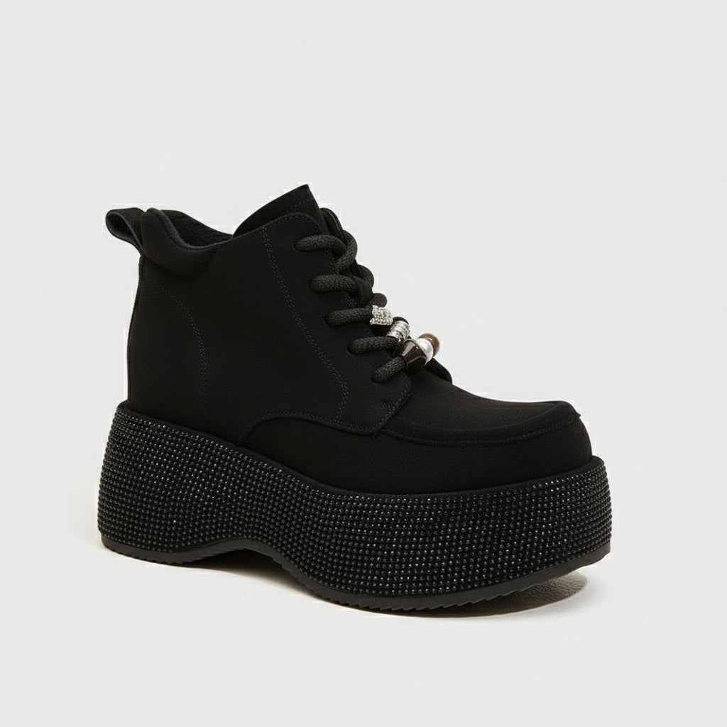 Black platform boot with rhinestone details on a white background