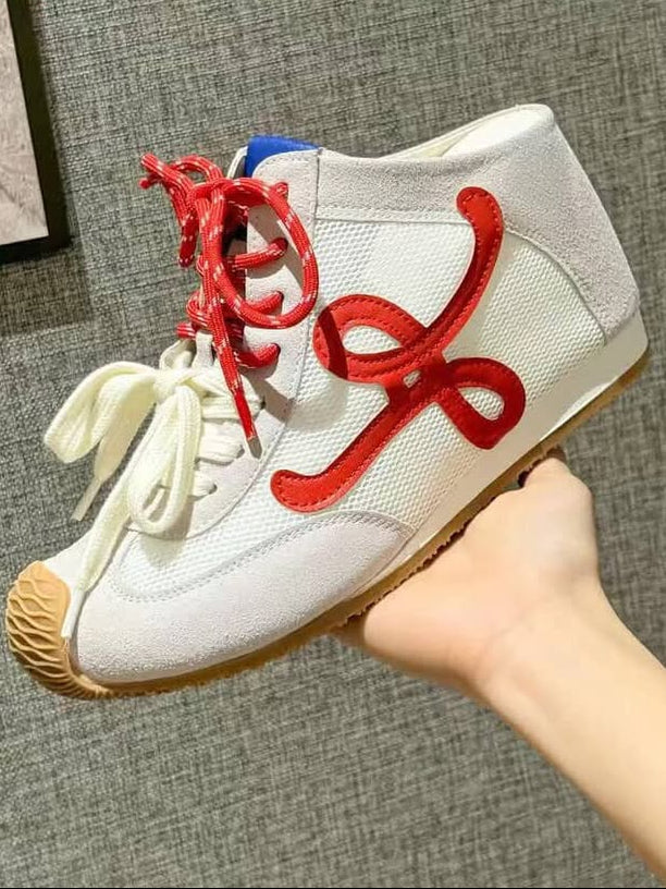 White sneaker with red laces 
