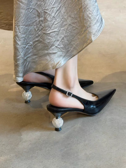 Black pointed-toe slingback shoes with sparkling ball heels