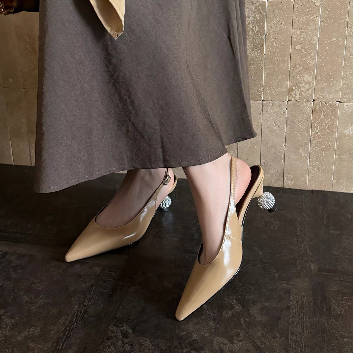 Nude beige pointed-toe slingback shoes with crystal ball heels