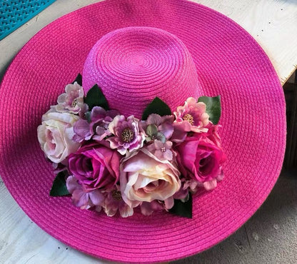 Hot pink wide-brim straw sun hat with pink, purple and ivory flowers