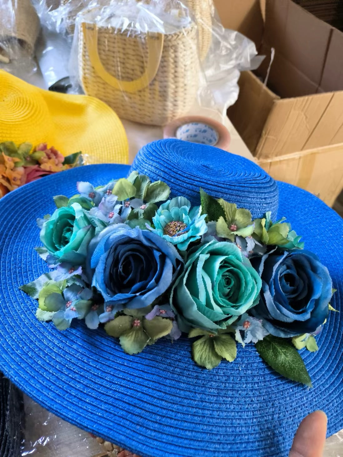 Royal blue straw sun hat with blue and teal floral decoration
