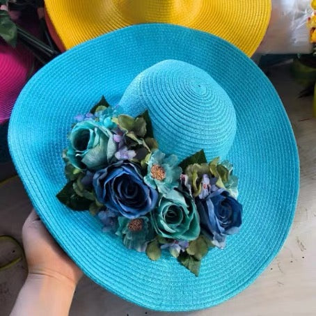 Turquoise straw sun hat decorated with blue and teal roses