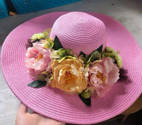 Light pink floral straw sun hat with peach and blush flowers