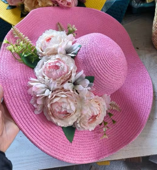 Pink straw sun hat decorated with pale pink and ivory flowers