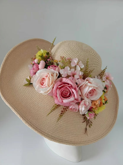 Beige wide-brim straw sun hat decorated with pink and ivory roses