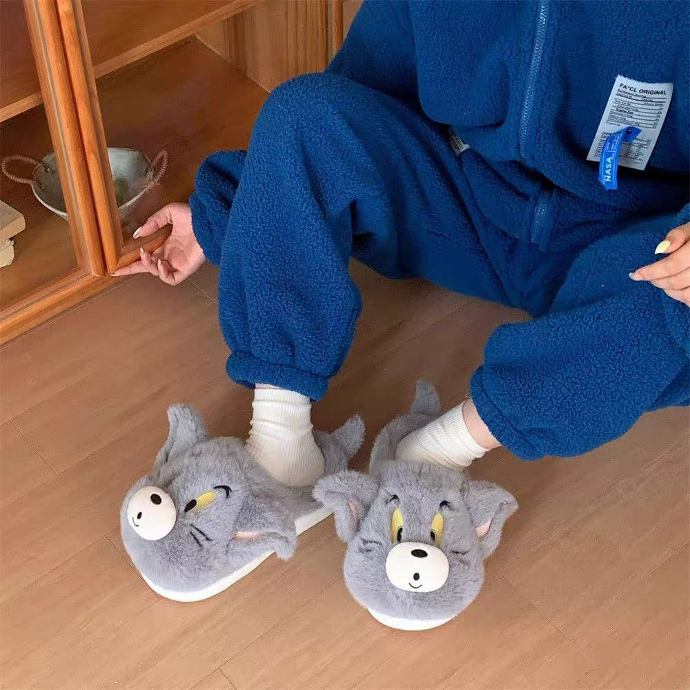 Grey Tom plush slippers worn with blue loungewear