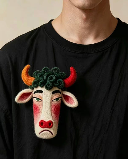 Handmade felt bull zodiac brooch with curved red and orange horns
