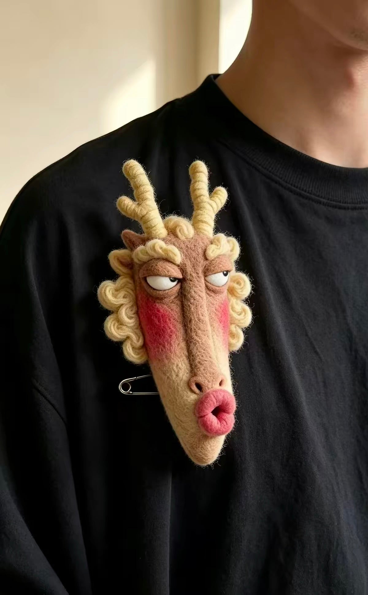 Handmade felt zodiac character brooch with curled horns and rosy cheeks