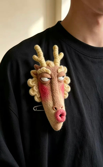 Handmade felt zodiac character brooch with curled horns and rosy cheeks