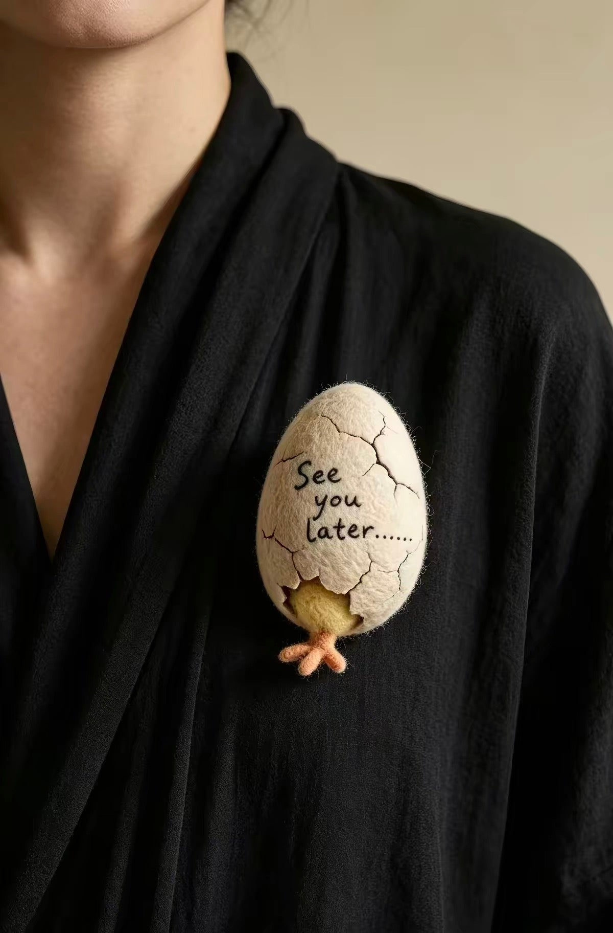Handmade felt chick in a cracked eggshell with See you later lettering