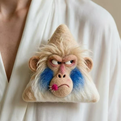 Handmade felt monkey-style character brooch with blue cheek details