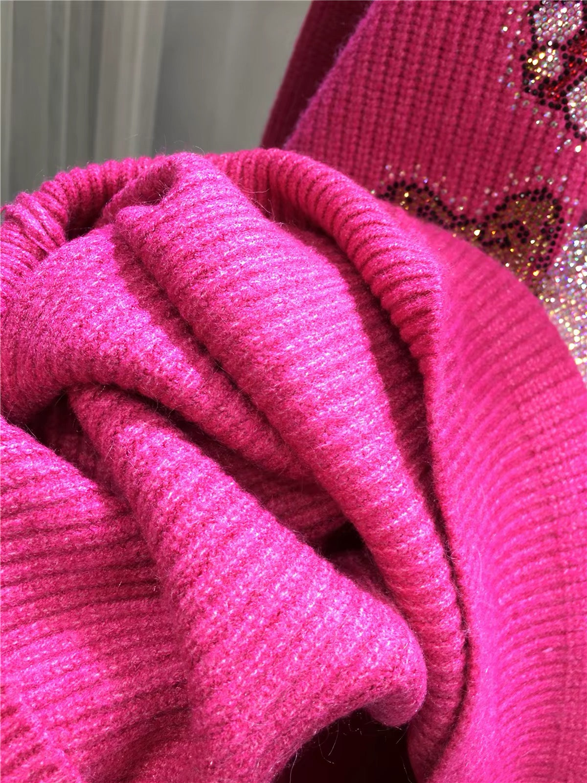 Close-up of hot pink ribbed knit and stand collar