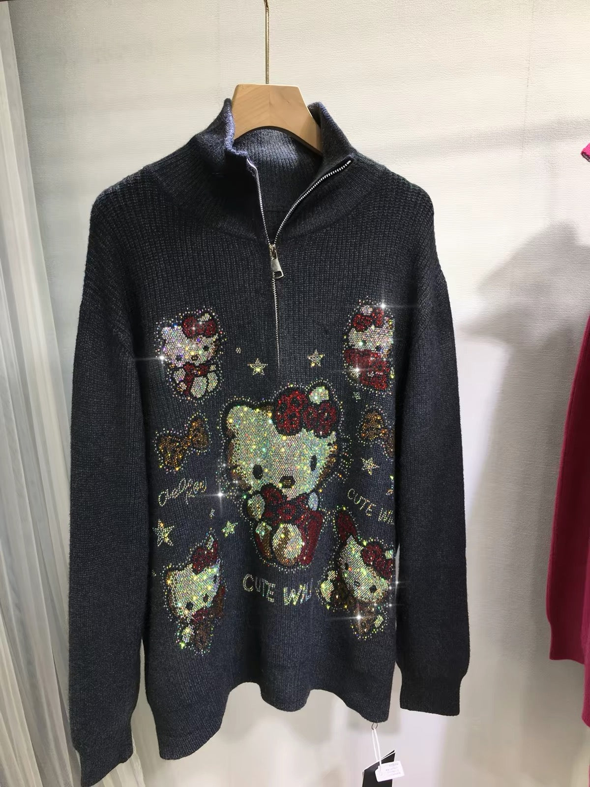 Full view of black oversized rhinestone zip-up knit sweater