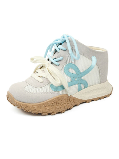 White sneaker with blue laces and sole on a white background