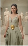Model wearing gold sculpted buckle belt with sage green dress — front view