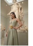 Model wearing gold sculpted buckle belt with sage green dress — full outfit