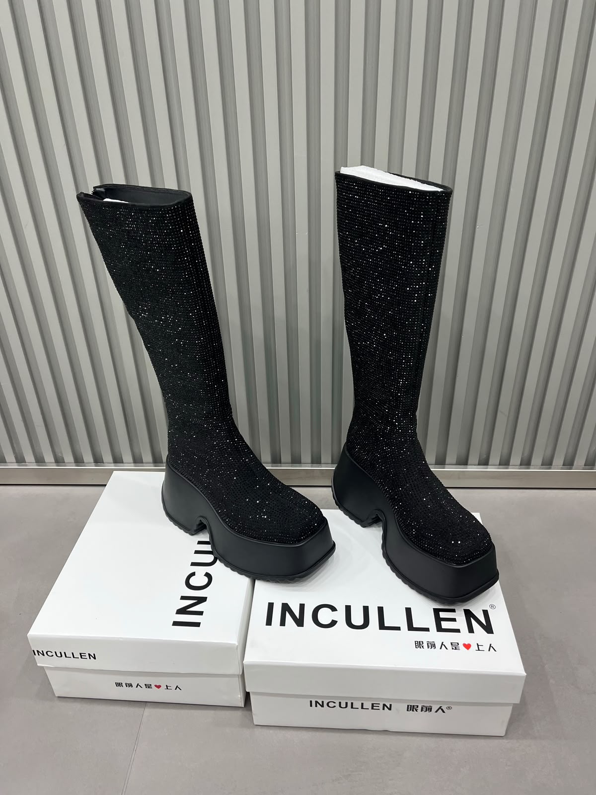 Black sparkling rhinestone knee-high platform boots with chunky black soles