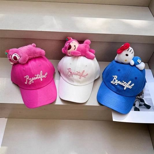 Plush character baseball caps in pink, white and blue