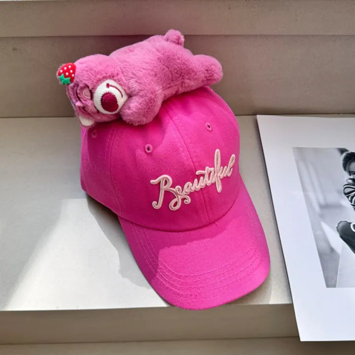 Bright pink baseball cap with plush topper