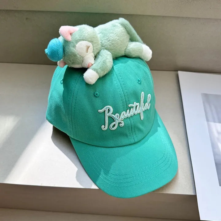 Turquoise baseball cap with plush cat topper