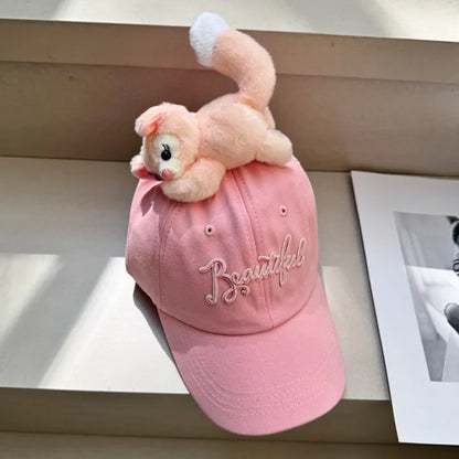 Pink baseball cap with plush animal topper