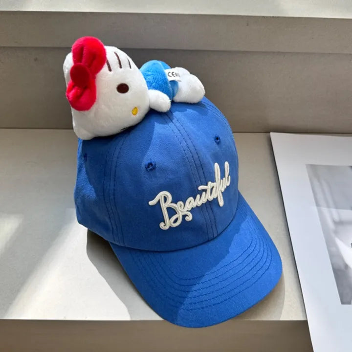 Blue baseball cap with white plush character topper