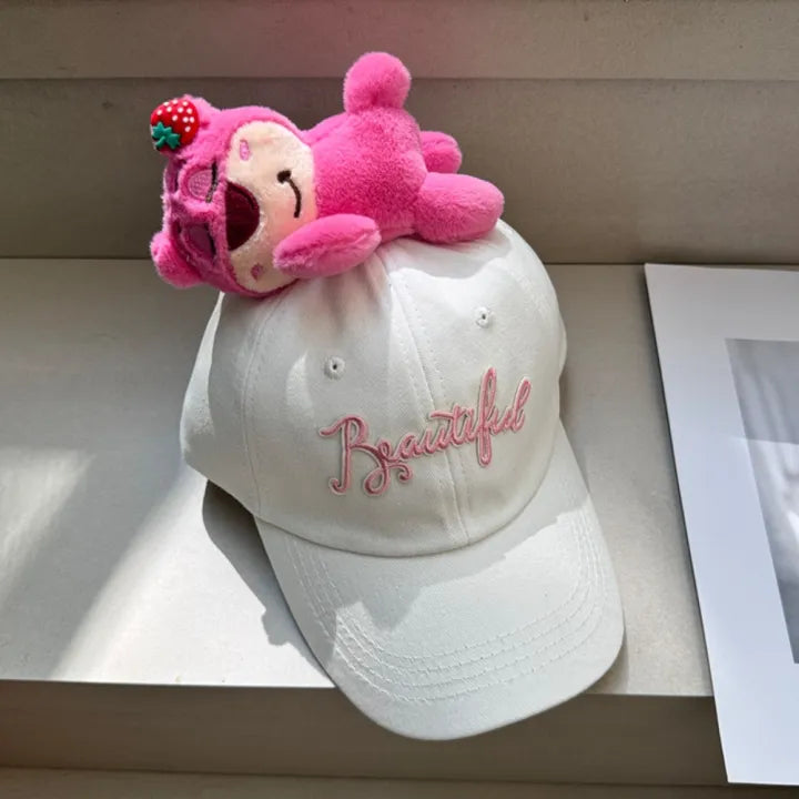 White baseball cap with pink plush character topper