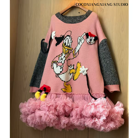 Pink knit sweater dress with cartoon duck graphic, charcoal contrast sleeves and layered pink tulle skirt