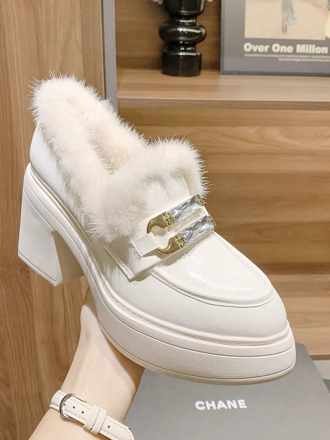 White faux-fur crystal buckle loafer close-up