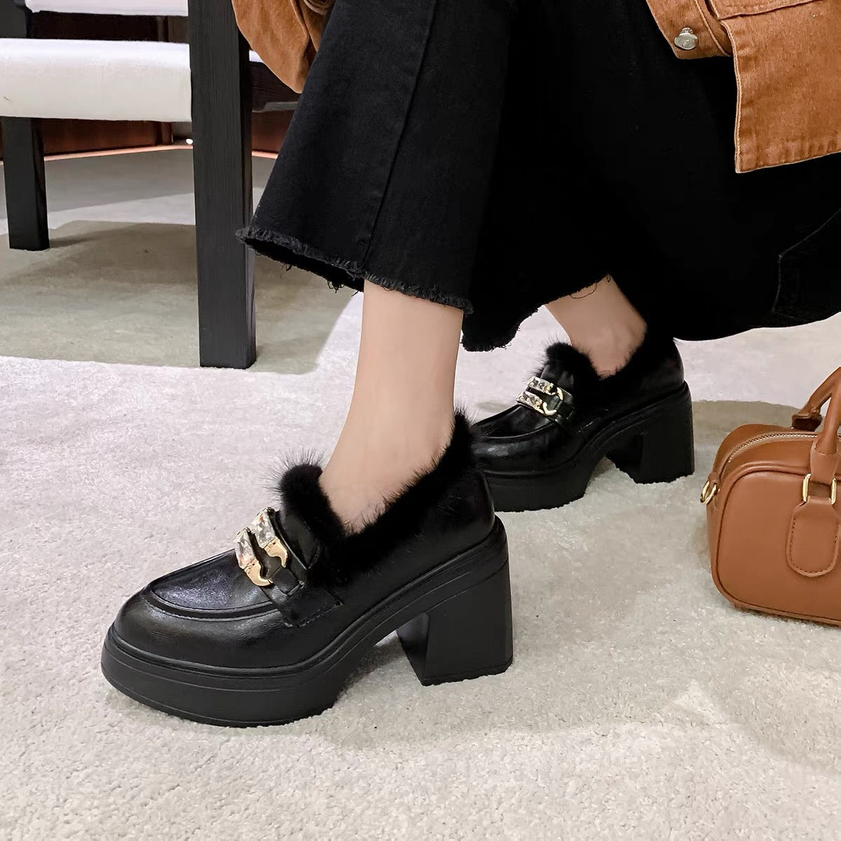 Black faux-fur crystal buckle chunky loafers styled on feet