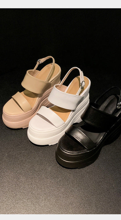 Three sandals in black, white, and beige on a dark background