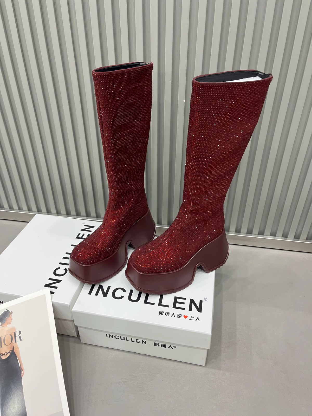 Red burgundy sparkling rhinestone knee-high platform boots shown from a second angle